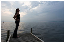 Woman standing alone on a dock