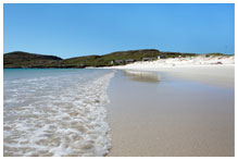 A clear beach as the surf comes in