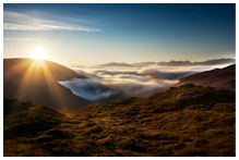 A sun rise over a mountain range.